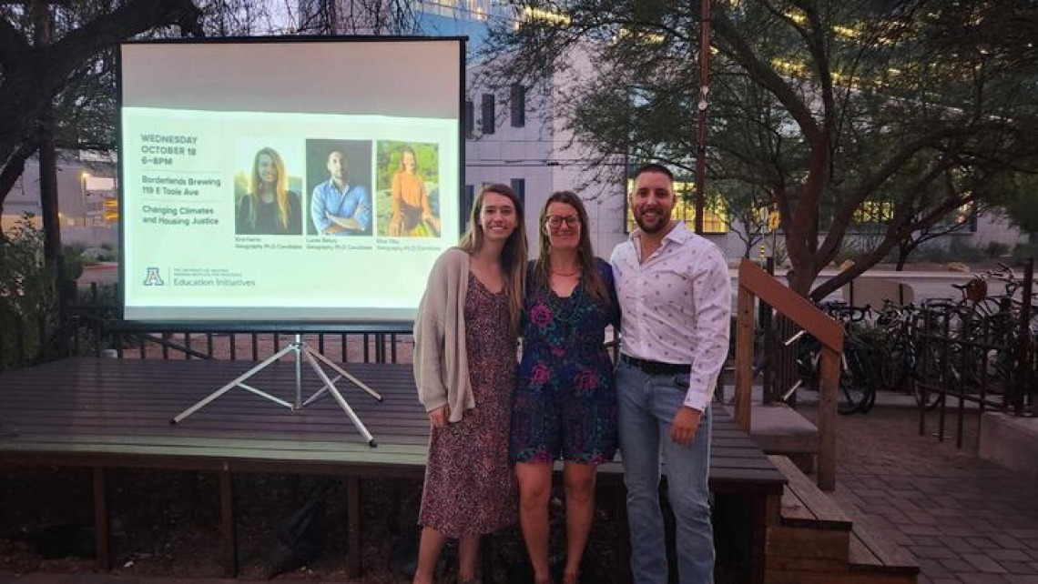 Three Carson Scholars at Borderlands Brewing Company posing next to a screen featuring their presentation title slide. 