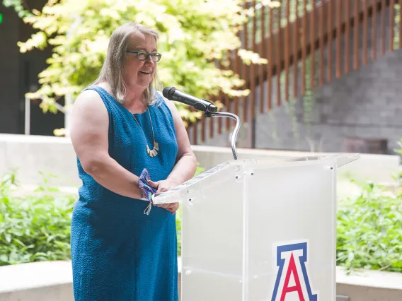 Diana Liverman speaking at podium in ENR2 building