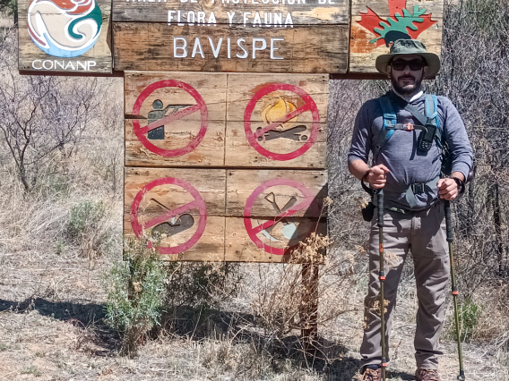 Miguel Grageda in front of environmental protection sign