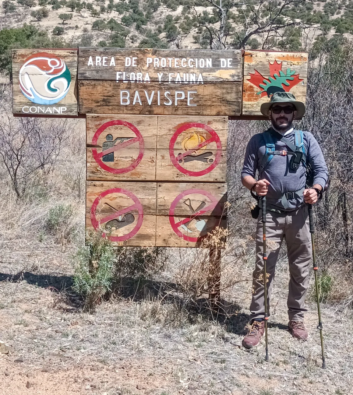 Miguel Grageda in front of environmental protection sign